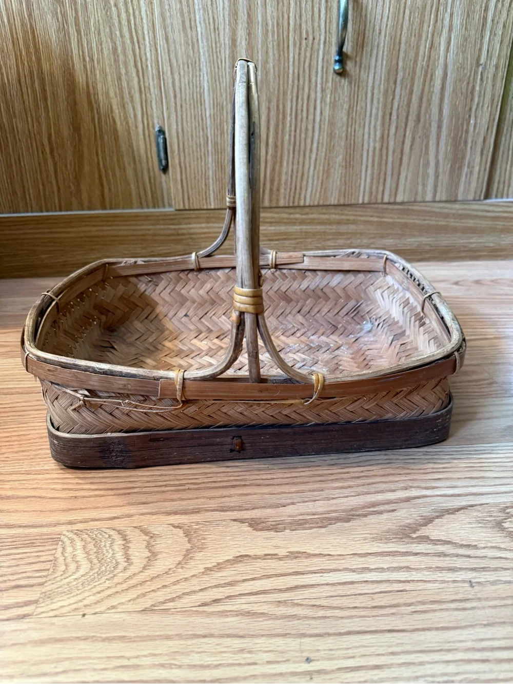 Vintage Zhejiang Chinese woven rattan and wood handled basket with a carved